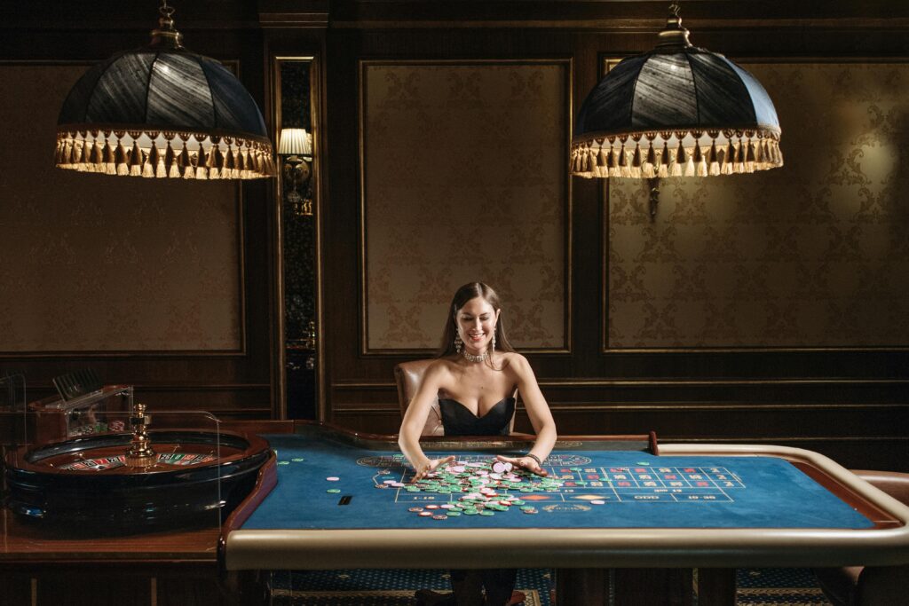 A Woman in Black Tube Top Gathering the Casino Tokens on Gaming Table